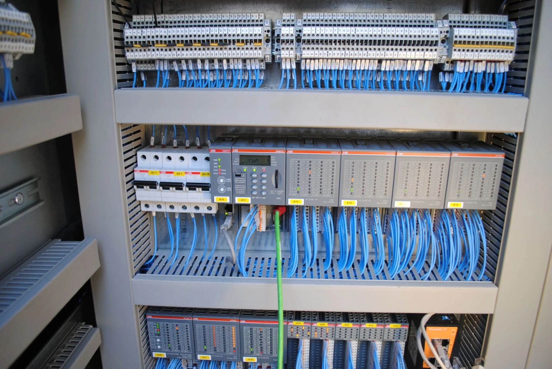 Inside a control panel with an ABB AC500 PLC and terminal blocks wired by TD2E